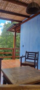 a patio with a table and a bench on a porch at Chalé Davivi in Socorro +49 photos