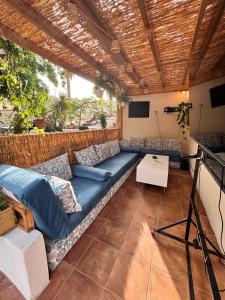 a living room with a blue couch on a patio at Blue Ocean Costa Adeje 502 in Playa de las Americas