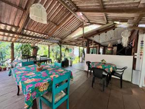 a dining room with a table and chairs at Tekoah Pousada in Paranaguá