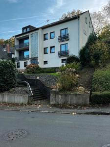 a white building with stairs in front of it at One Seven - BRIGHT Collection in Koblenz
