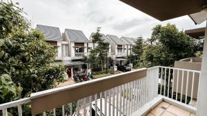 a view of a row of houses from a balcony at Lee Simple House - Summarecon Bandung in Tegallebu