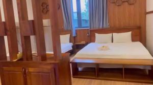 a bedroom with a bed with a cat sitting on it at Sao Biển Phú Quốc in Phú Quốc