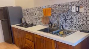 a kitchen with a sink and a refrigerator at Sao Biển Phú Quốc in Phú Quốc