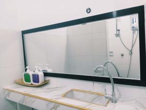 a mirror above a sink in a bathroom at Hiddennest Guest house in Alcantara +41 photos