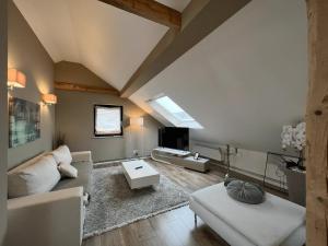 a living room with a couch and a table at One Seven - BRIGHT Collection in Koblenz