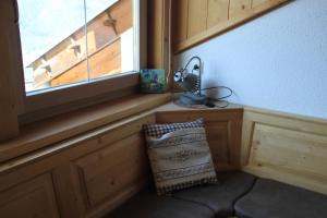 a window in a room with a chair and a lamp at Hofschank Reinalterhof in Malles Venosta