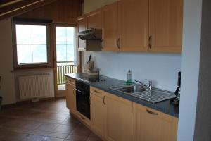 a kitchen with a sink and a stove at Hofschank Reinalterhof in Malles Venosta