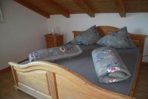 a bedroom with a bed with pillows on it at Hofschank Reinalterhof in Malles Venosta +9 photos
