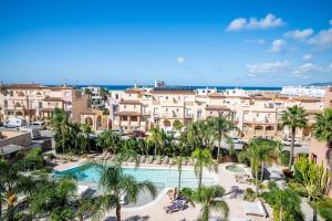 a view of a resort with a pool and palm trees at Hotel Tarifa Lances, a member of Radisson Individuals in Tarifa