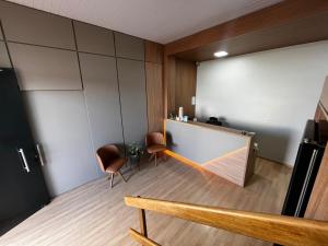 a lecture room with a podium and two chairs at Hotel Sara - Ampere in Ampère +26 photos
