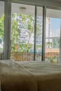 a bedroom with a bed and a large window at Green Island Inn in Fort Lauderdale +42 photos