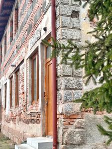 a brick building with a red door on it at Apartment Kundratice in Košťálov