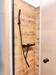 a shower with a black shower head on a wall at Apartment Kundratice in Košťálov