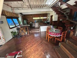 a dining room and kitchen with a table and chairs at Kuyas Tree House in Puerto Princesa City
