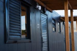 a blue building with a door and a window at Studio Container - Conforto e Ótima Localização in Sinop +22 photos