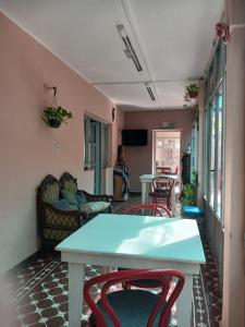 a living room with a blue table and chairs at La Casona Hostel in Bermejo