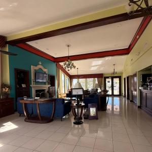 a large room with a lobby with blue walls at Americas Best Value Inn & Suites-Alvin/Houston in Alvin