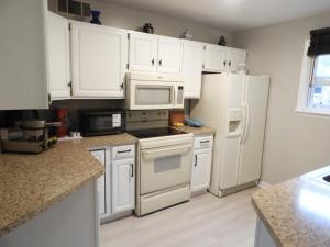 a kitchen with white cabinets and white appliances at CONDO 101c in Camp Hill