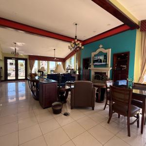 a living room filled with furniture and a dining room at Americas Best Value Inn & Suites-Alvin/Houston in Alvin