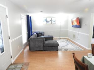 a living room with a couch and a chair at CONDO 101c in Camp Hill