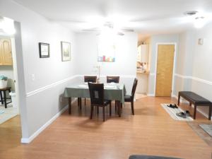 a dining room and living room with a table and chairs at CONDO 101c in Camp Hill