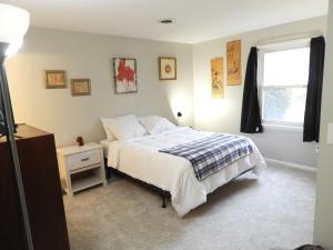 a bedroom with a bed and a window at CONDO 101c in Camp Hill