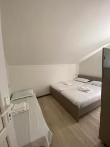 a white room with a bed and a table at Barakat Hotel in Ureki
