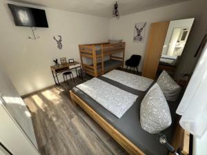 a bedroom with a bed and a desk and a bed at Gästehaus Luna in Rust +9 photos