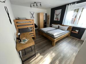 a small room with a bed and a bunk bed at Gästehaus Luna in Rust