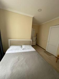 a bedroom with a bed with two pillows on it at Barakat Hotel in Ureki +1 photo
