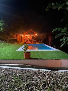 a house with a swimming pool at night at Finca Bellavista in Villeta