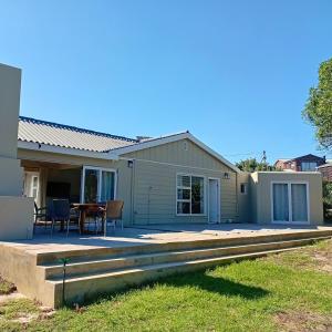 a house with a patio and a table at Weekend at Bernies in Pringle Bay