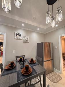 a dining room with a table and a refrigerator at Lumiere Suites in Georgetown
