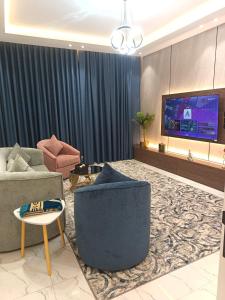 a living room with a couch and a tv at لافيرا هاوس in Taif