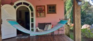 a hammock on the porch of a house at Suite em Lumiar in Lumiar