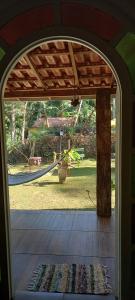 an open door to a yard with a swing at Suite em Lumiar in Lumiar +8 photos