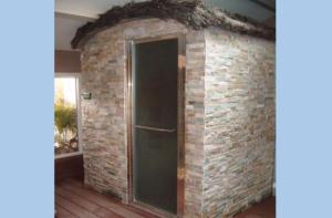 a brick wall with a door in a room at La casa du clos in La Bernerie-en-Retz +12 photos