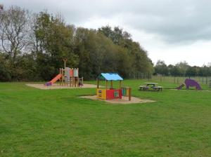 a park with two playground equipment and a picnic table at La casa du clos in La Bernerie-en-Retz