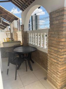 a black table and chairs sitting on a balcony at Hotel orla House in Petrolina