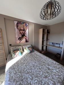 a bedroom with a large bed with a painting on the wall at Studio zen climatisé piscine parking in Balaruc-les-Bains +27 photos