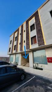 a building with a blue arrow on the side of it at الزاوية للشقق الفندقية in Medina
