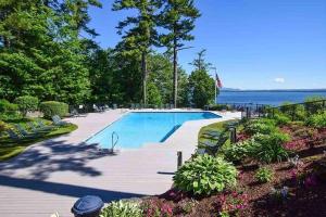 a large swimming pool next to the ocean at Samoset Vacation in Gilford