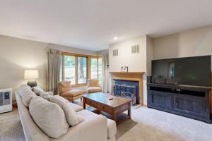 a living room with a couch and a tv at Samoset Vacation in Gilford