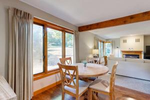 a kitchen and living room with a table and chairs at Samoset Vacation in Gilford