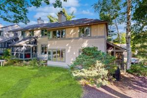 a large white house with a yard at Samoset Vacation in Gilford