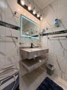 a bathroom with a sink and a mirror at Lumiere Suites in Georgetown +27 photos