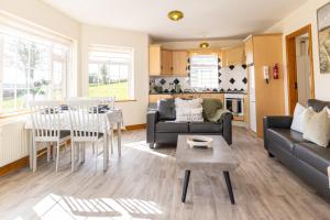 a living room with a couch and a table at Hillside House - Rose Cottage in Ballinamuck +8 photos