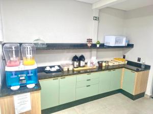 a kitchen with a blender on top of a counter at Hotel Pousadas Club Centro in Sorocaba +41 photos