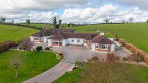an aerial view of a house in a field at Hillside House - Rose Cottage in Ballinamuck