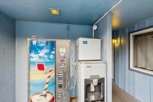 a room with a gas pump and a refrigerator at Lamplighter Inn - 115 Turtle Bay in Bandon